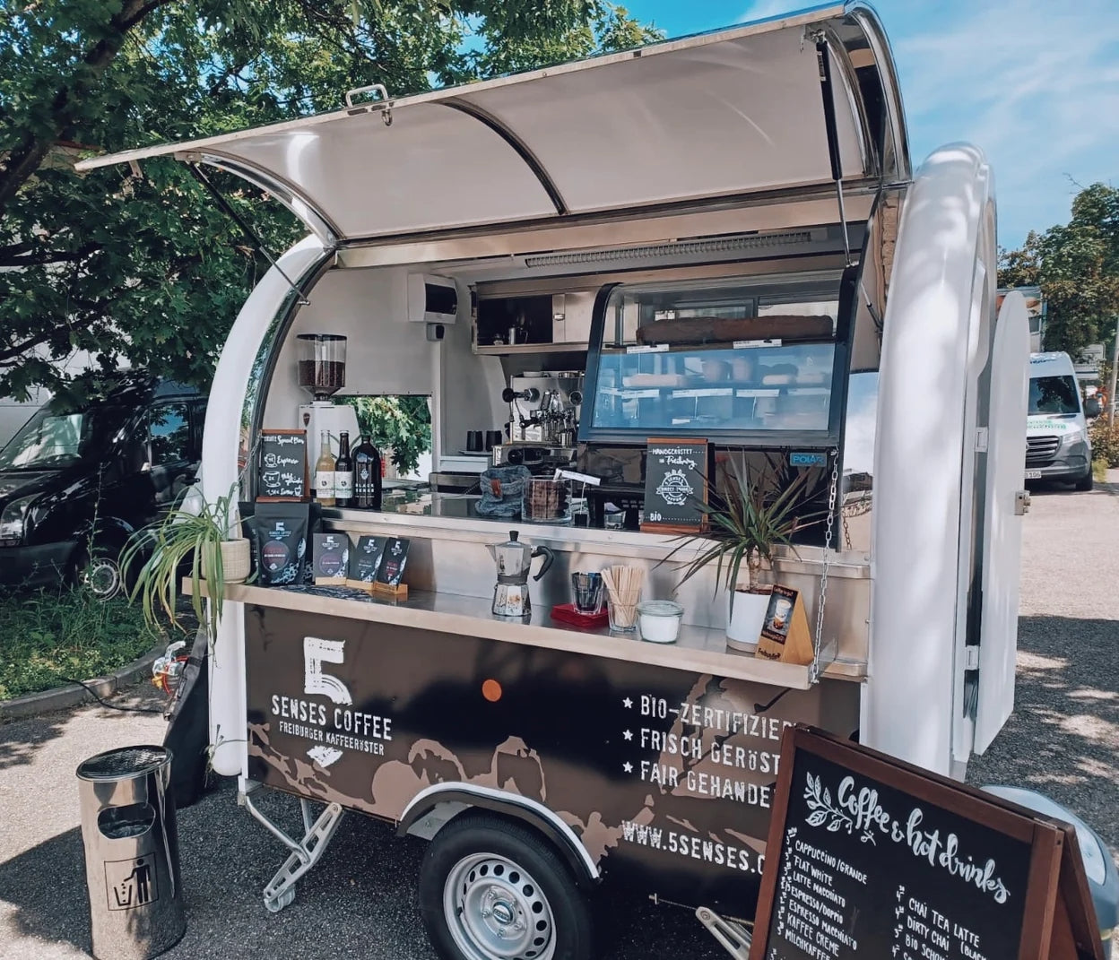 Latte Art und Gäste im Gespräch bei einer Feier mit Kaffee-Catering